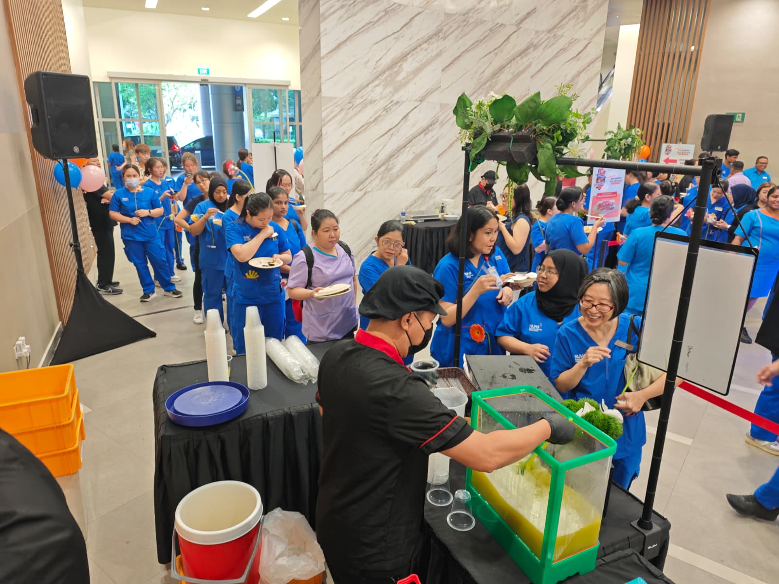 Healthcare staff queueing at a live food and beverage station during a hospital staff appreciation event