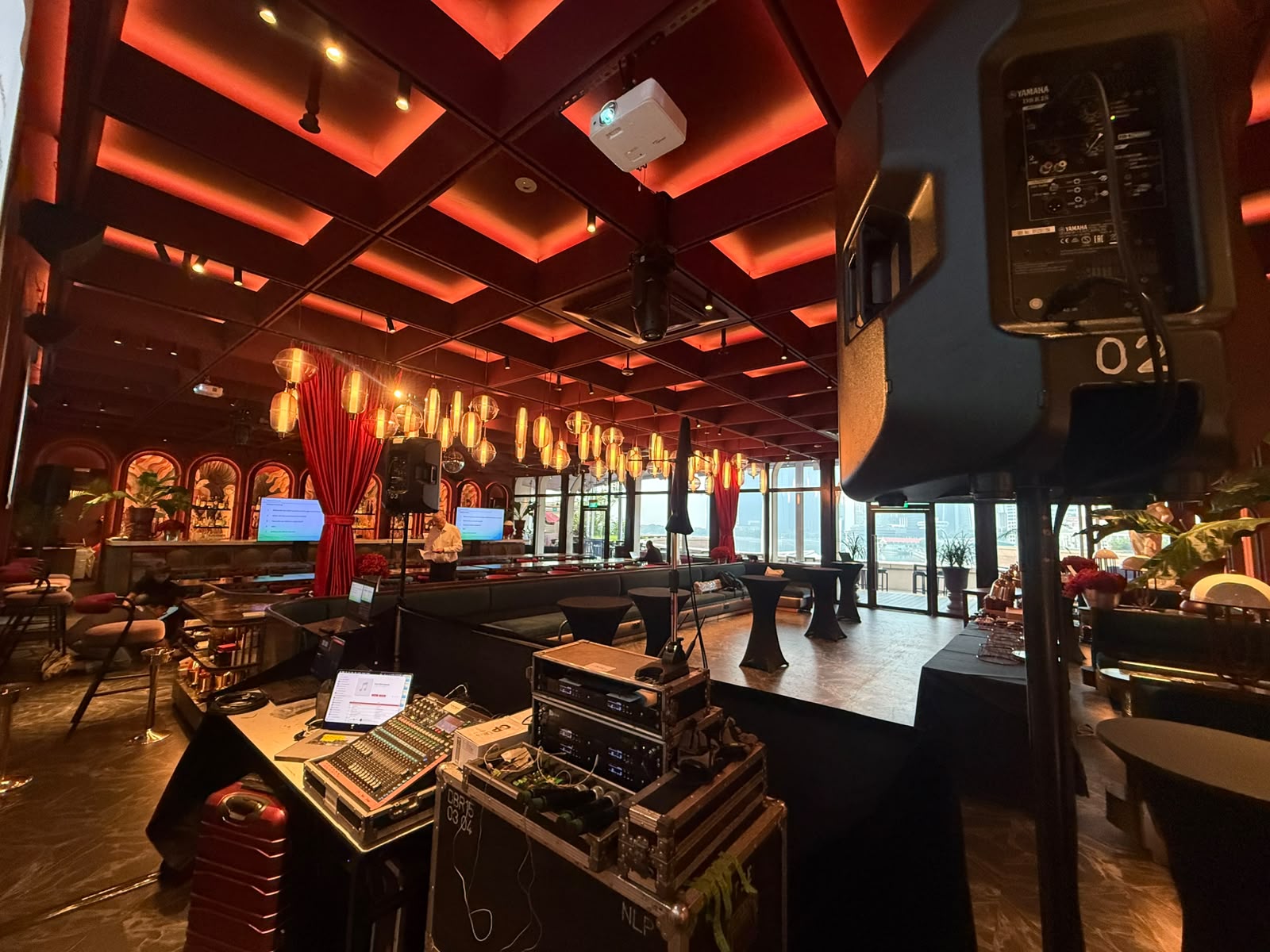 Audio console, wireless microphones and speakers set up at an event venue in Singapore