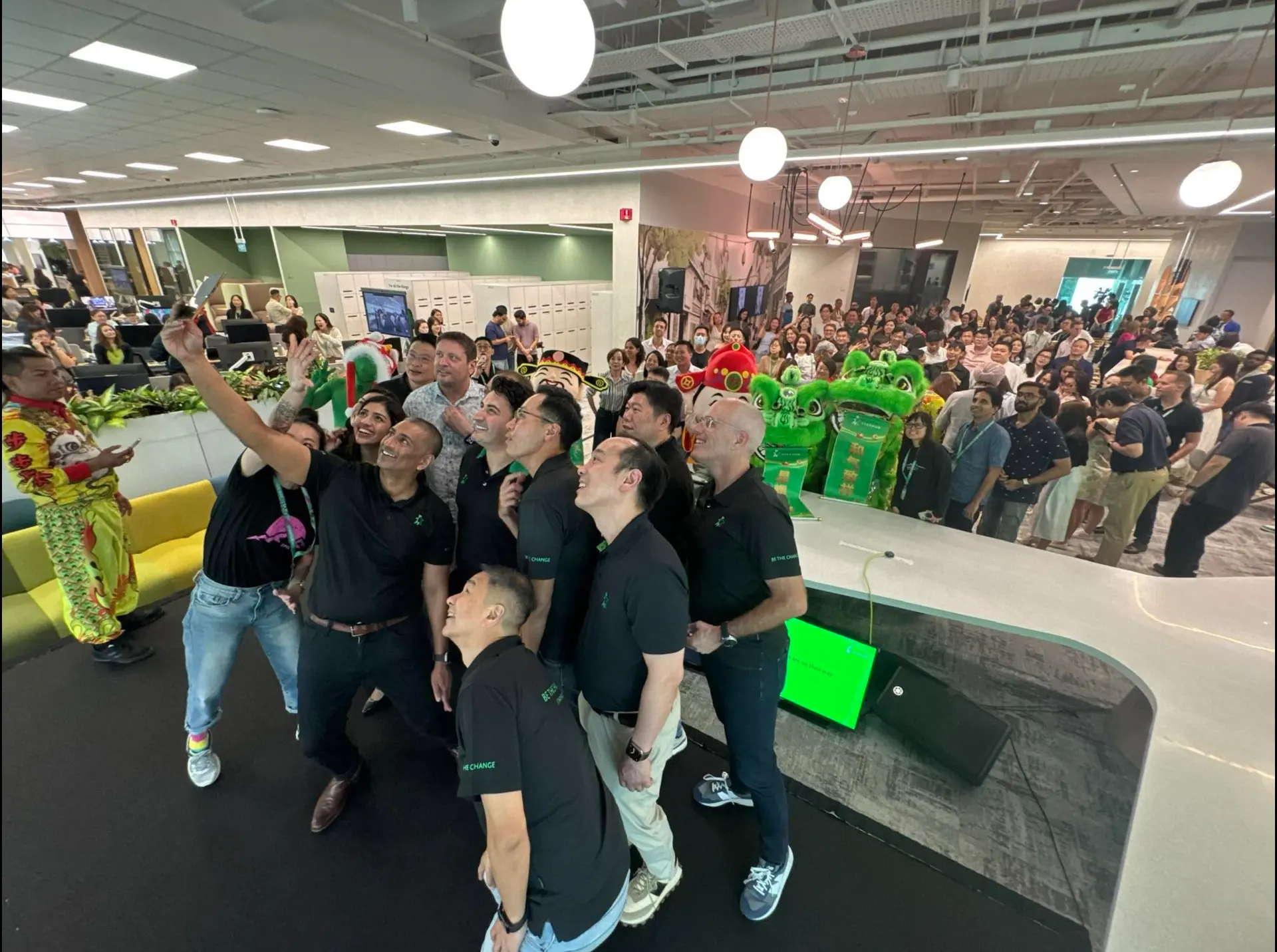 Corporate celebration event with lion dance performance and staff group photo in Singapore