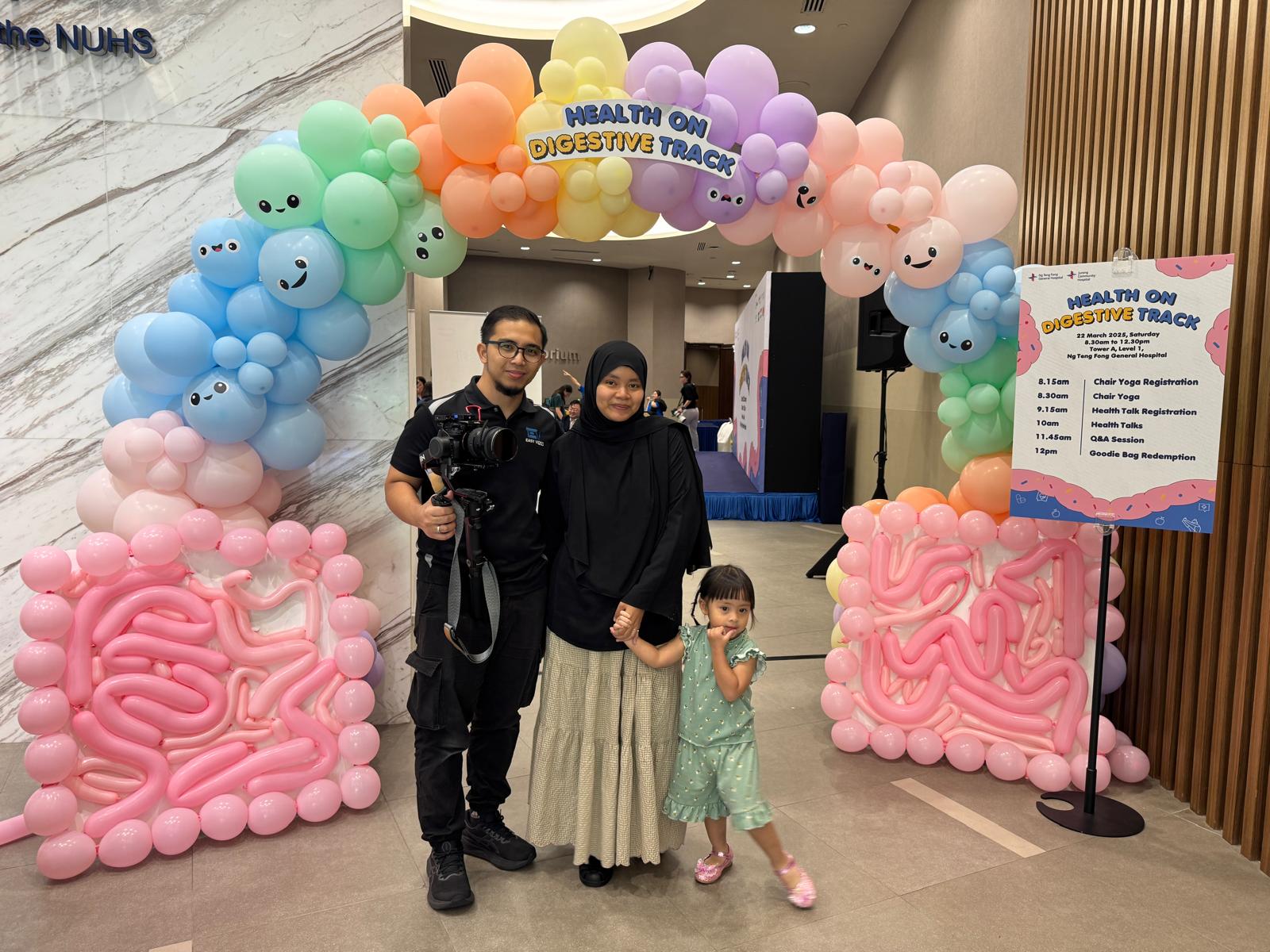 Colourful balloon arch and experiential health event entrance at Ng Teng Fong General Hospital