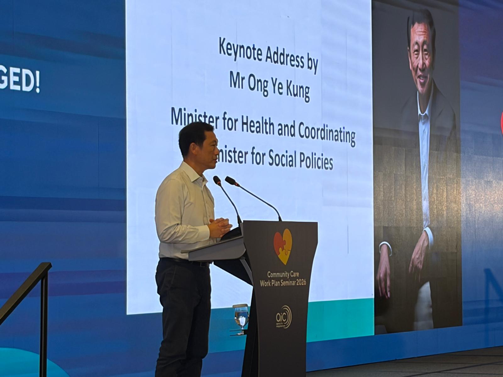 Keynote address delivered at a branded lectern with speaker graphics on the main screen
