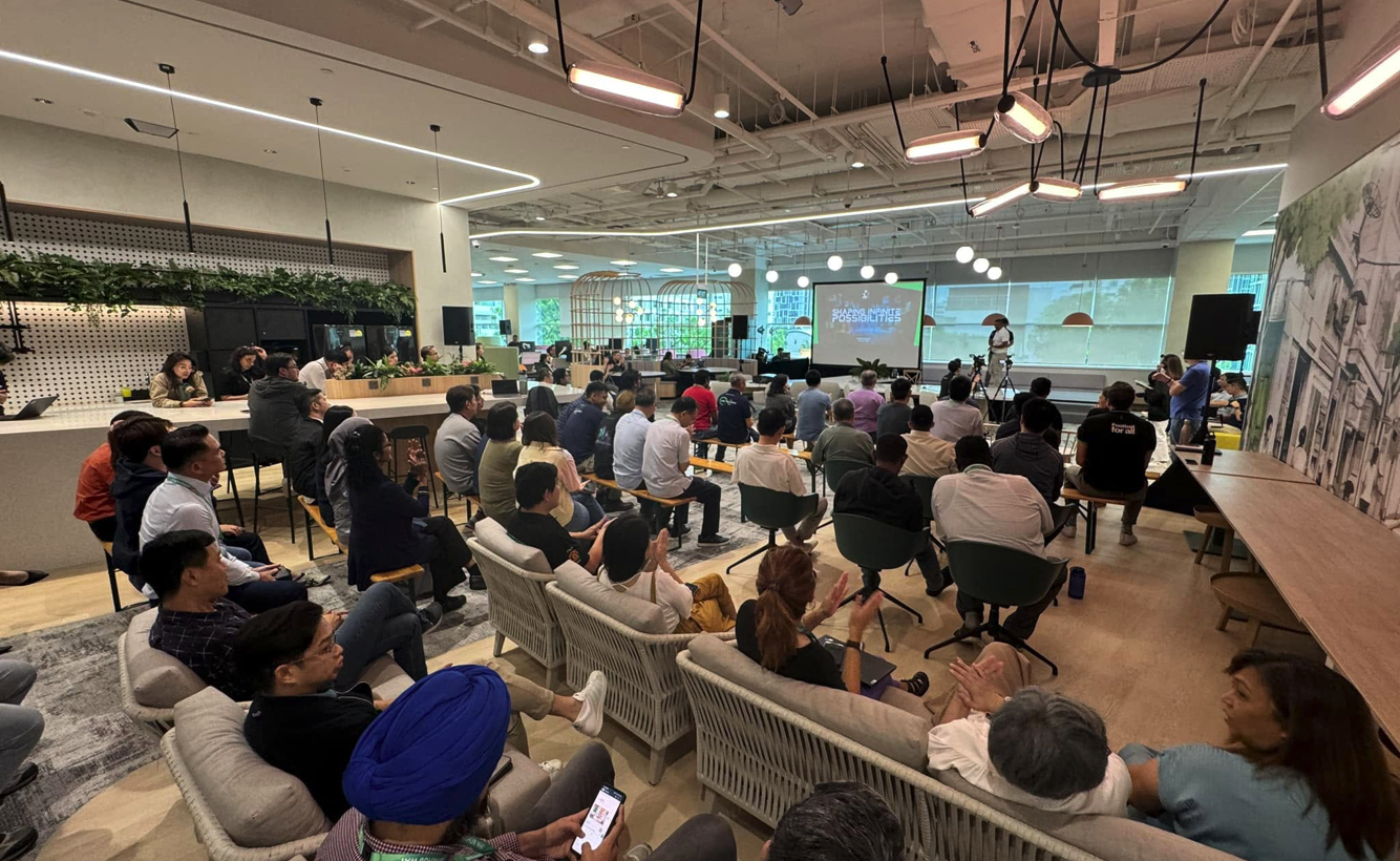 Attendees watching a live session at a hybrid conference